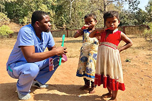 jean paul teaching the girls to brush their teeth